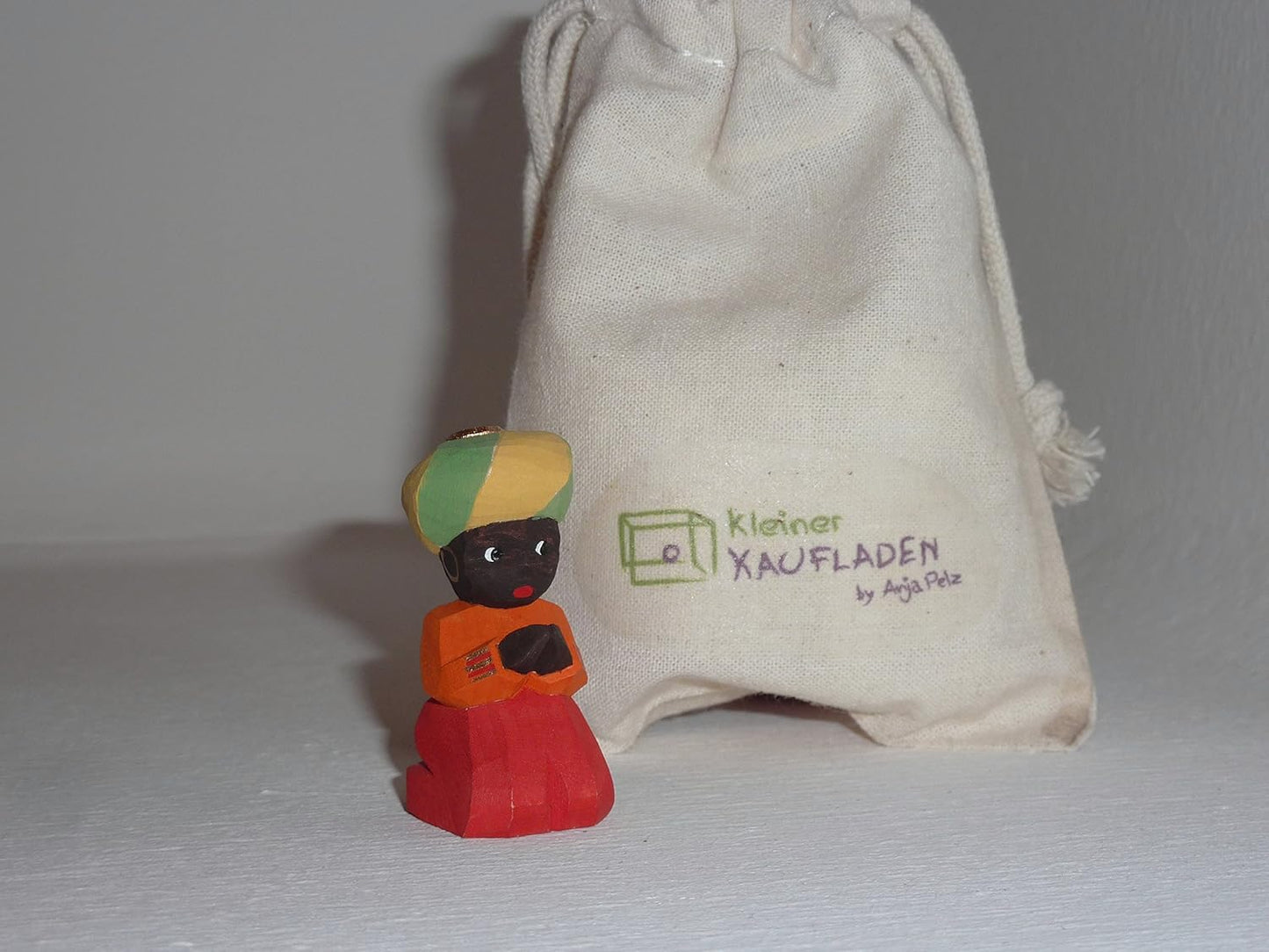 Kniende Krippenfigur mit Beutel